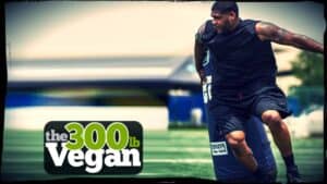 Defensive lineman David Carter is shown in training skimming past a tackle dummy. In a lower left inset the words “The 300 pound Vegan” are displayed.