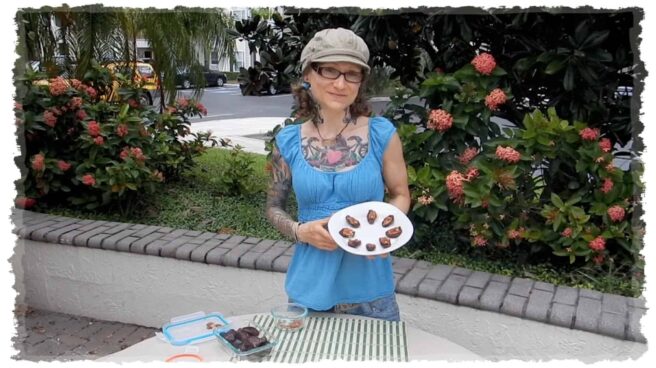 Emily Moran Barwick of Bite Size Vegan is shown with a plate of delicious looking pecan pie bites.
