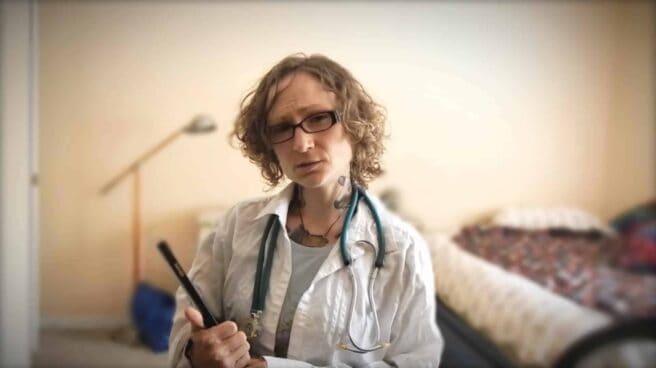 Emily Moran Barwick of Bite Size Vegan is shown dressed as a doctor with a white coat and stethoscope.