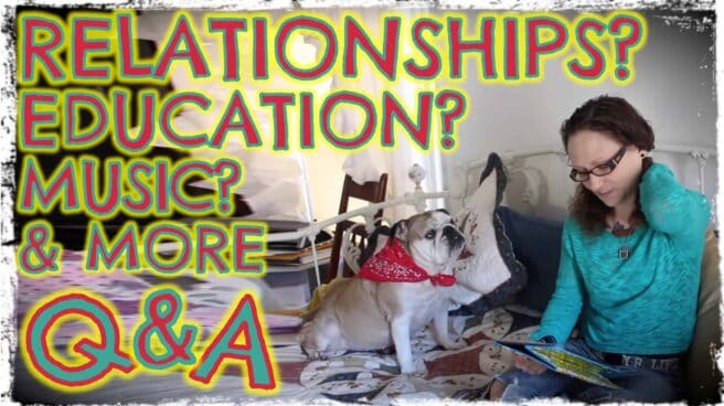 Emily Moran Barwick of Bite Size Vegan is shown sat on the bed, head down reading. Her beloved bulldog, Ooby, is next to her. Overlaying the image are the words “Relationships? Education? Music and more. Q and A”.