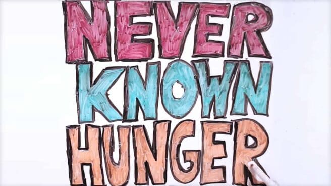 The phrase: never known hunger is written in large capital letters on a white board. Each word is a different color: red, blue and orange and the letters are outlined in black.