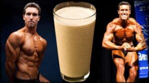 Vegan bodybuilder Derek Tresize is shown twice, once on the left, once on the right. In both he is in a body building pose, his muscles, taught and well defined. In the center is a glass of protein shake In cloe-up.