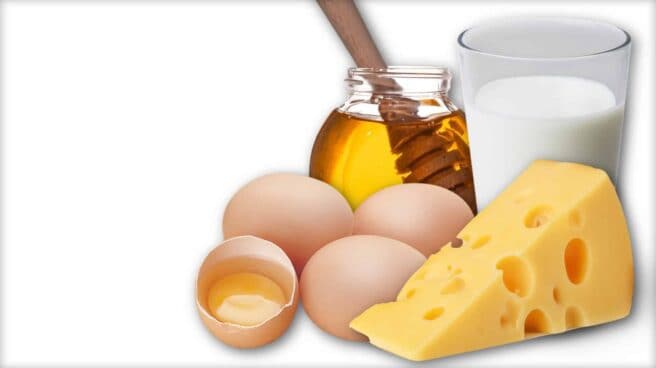 The image shows a number of hen’s eggs, a chunk of cheese, a glass of honey and a jar of honey.